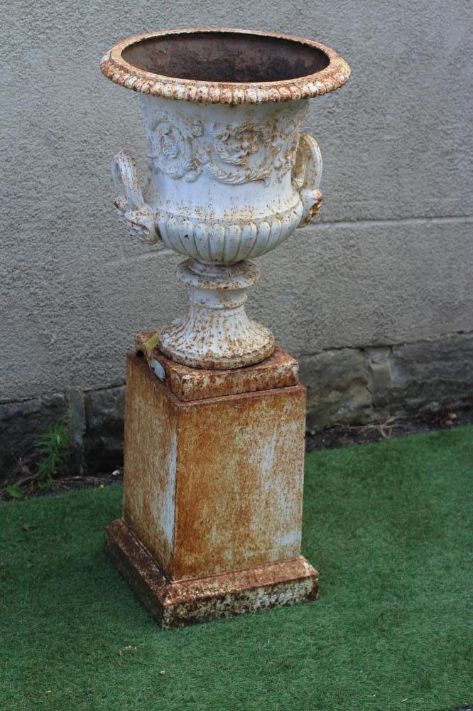 A VICTORIAN CAST IRON URN of half fluted campana form with mask loop handles Image