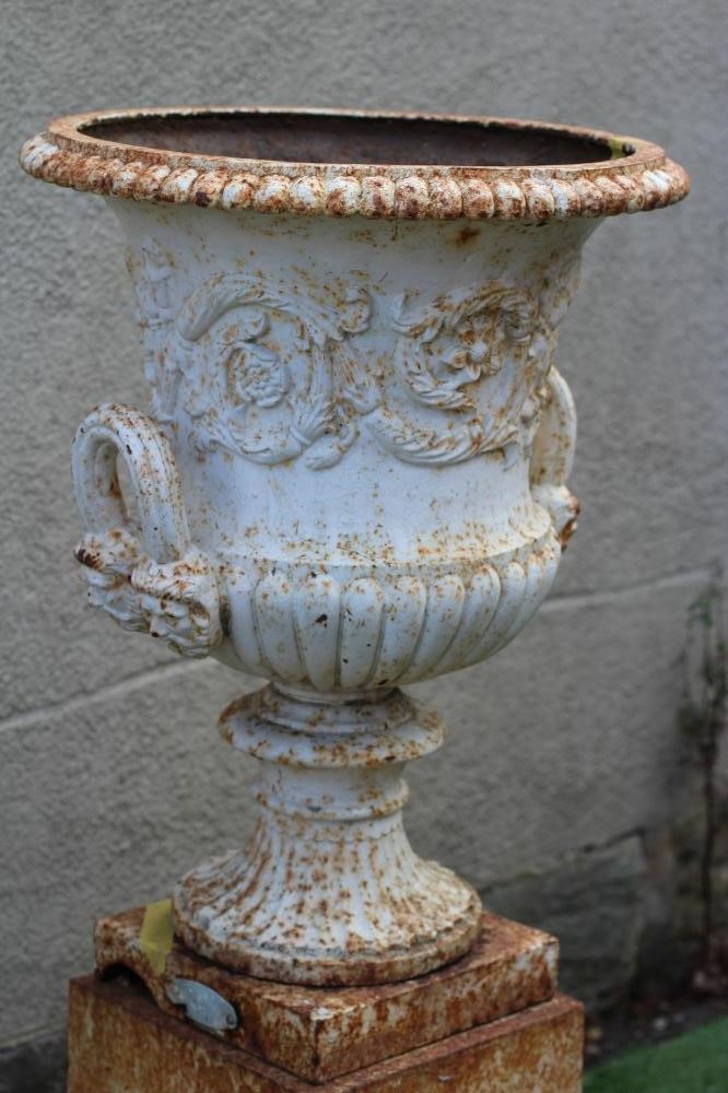 A VICTORIAN CAST IRON URN of half fluted campana form with mask loop handles Image