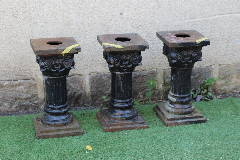 A SET OF THREE VICTORIAN CAST IRON IONIC COLUMNS with fluted shafts and stepped square base, 9 1/4" Image