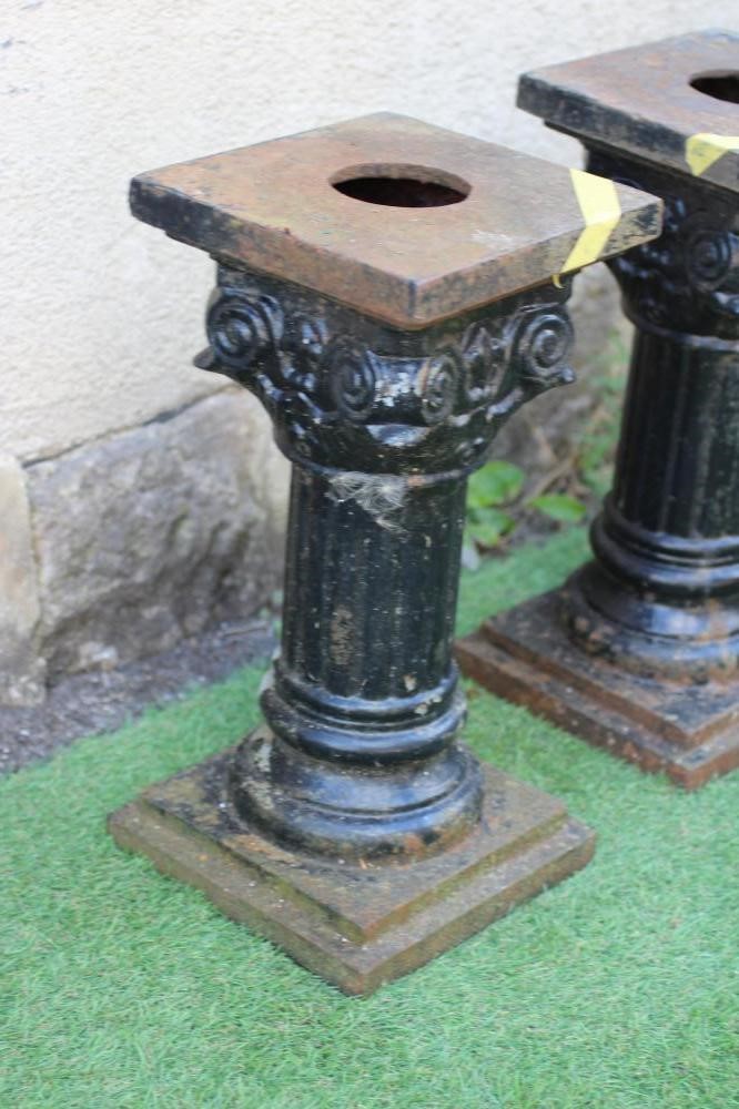 A SET OF THREE VICTORIAN CAST IRON IONIC COLUMNS with fluted shafts and stepped square base, 9 1/4" Image