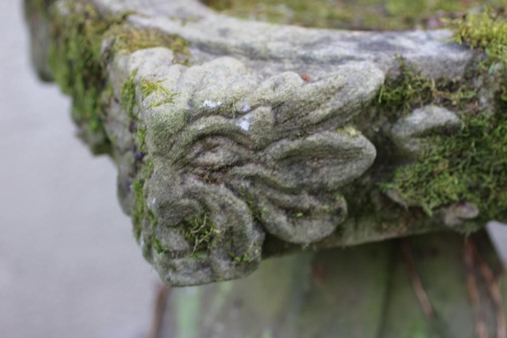 A SANDSTONE BIRD BATH, the square bowl with leaf and flower carved edge, on bulbous square stem with Image