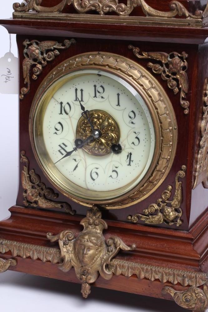 A FRENCH MAHOGANY AND BRASS TABLE CLOCK Image