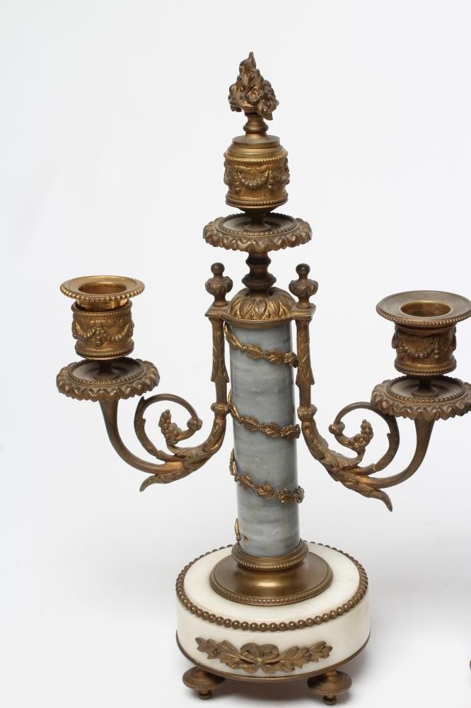 A FRENCH GILT METAL AND WHITE MARBLE CLOCK GARNITURE Image