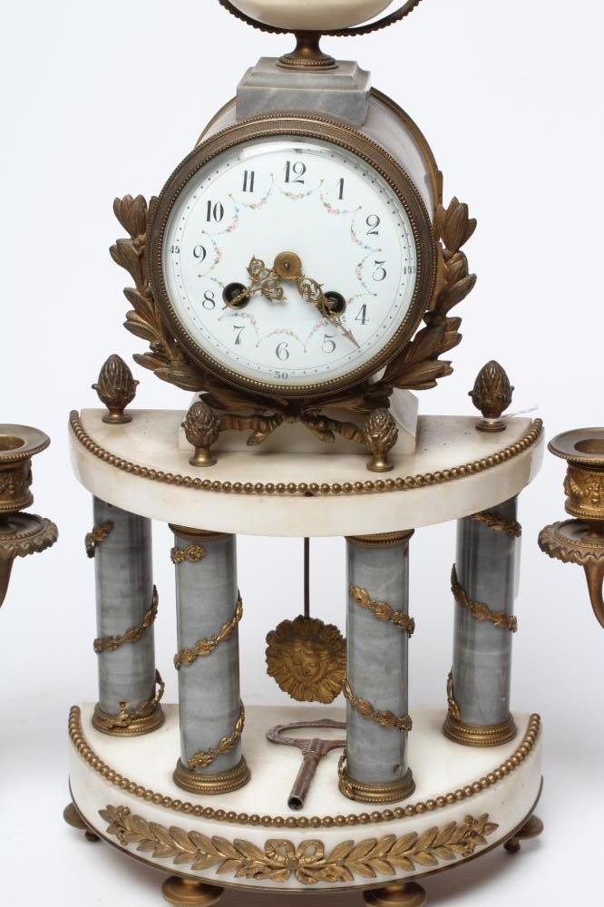 A FRENCH GILT METAL AND WHITE MARBLE CLOCK GARNITURE Image