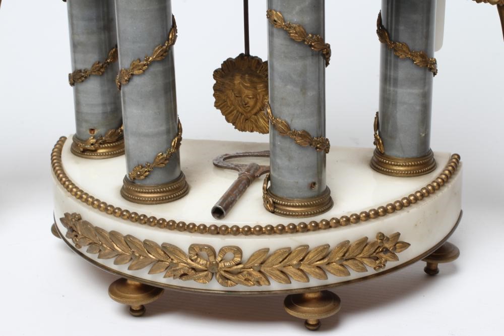 A FRENCH GILT METAL AND WHITE MARBLE CLOCK GARNITURE Image