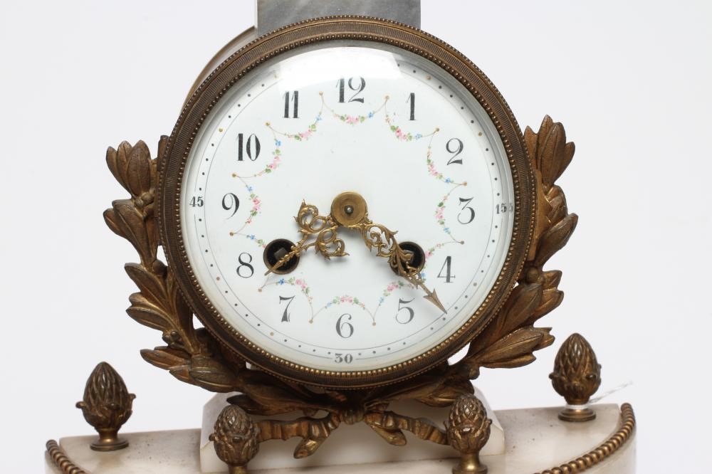 A FRENCH GILT METAL AND WHITE MARBLE CLOCK GARNITURE Image