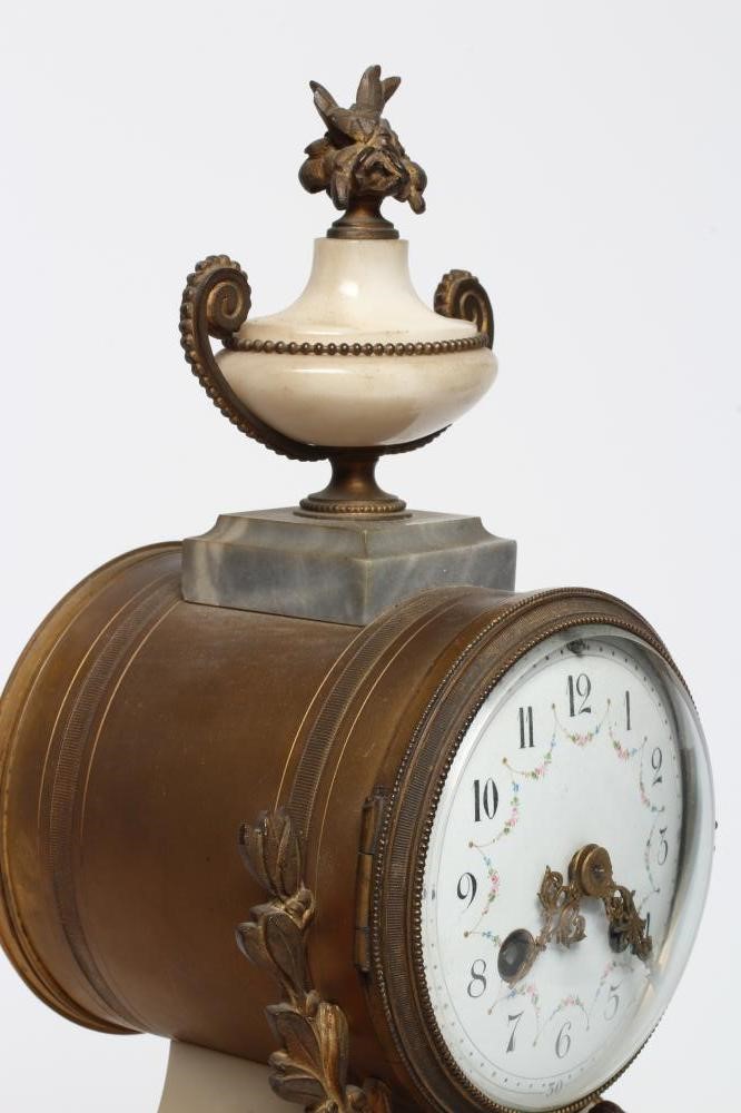 A FRENCH GILT METAL AND WHITE MARBLE CLOCK GARNITURE Image