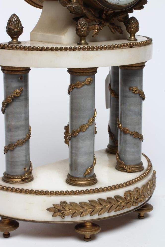 A FRENCH GILT METAL AND WHITE MARBLE CLOCK GARNITURE Image