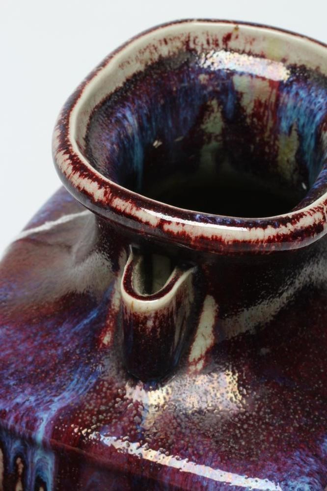 A CHINESE STONEWARE ARCHAISTIC VASE of square baluster form with two lug handles, in a streaky Image