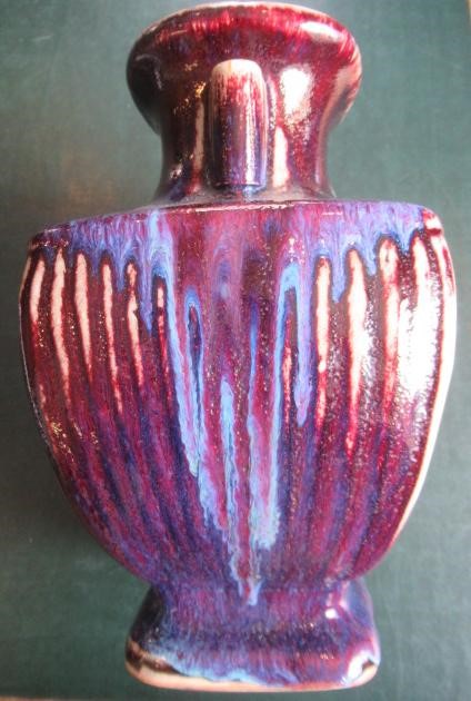 A CHINESE STONEWARE ARCHAISTIC VASE of square baluster form with two lug handles, in a streaky Image