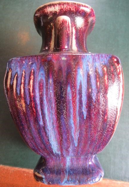 A CHINESE STONEWARE ARCHAISTIC VASE of square baluster form with two lug handles, in a streaky Image