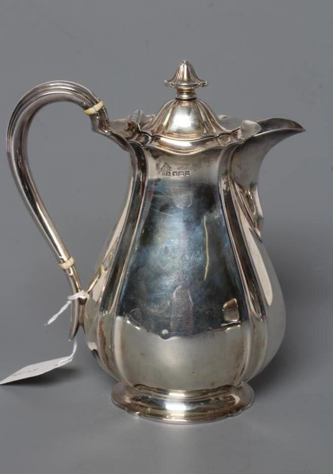 A SILVER HOT WATER JUG Image