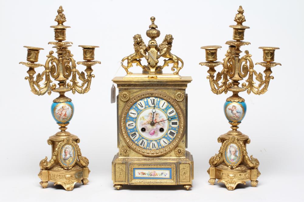 A FRENCH GILT METAL AND PORCELAIN CLOCK GARNITURE Image