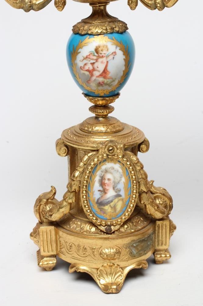 A FRENCH GILT METAL AND PORCELAIN CLOCK GARNITURE Image