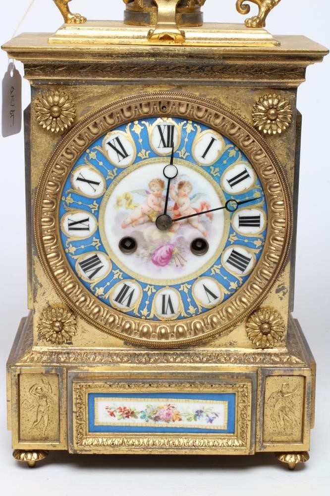 A FRENCH GILT METAL AND PORCELAIN CLOCK GARNITURE Image