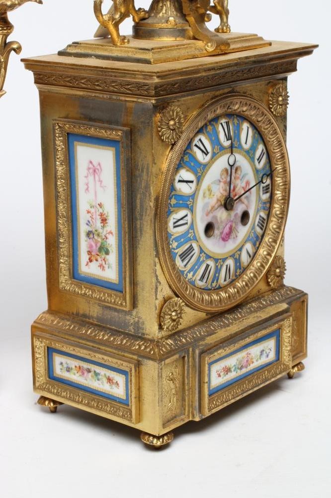 A FRENCH GILT METAL AND PORCELAIN CLOCK GARNITURE Image