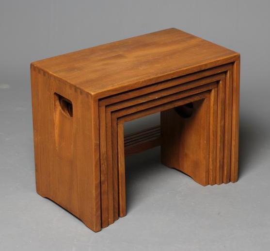 AN ERCOL LIGHT ELM NEST OF FIVE TABLES of oblong form, the solid sides pierced with inset loop Image