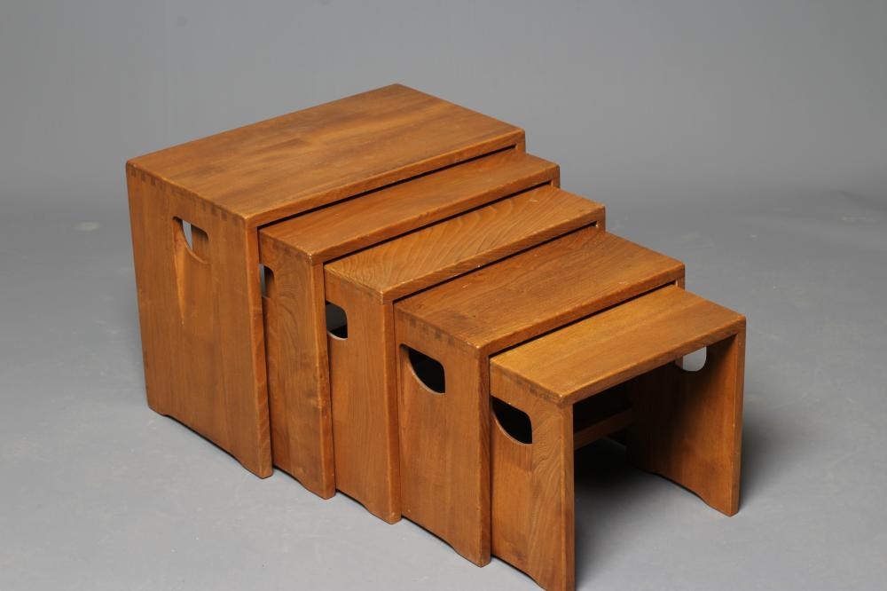 AN ERCOL LIGHT ELM NEST OF FIVE TABLES of oblong form, the solid sides pierced with inset loop Image