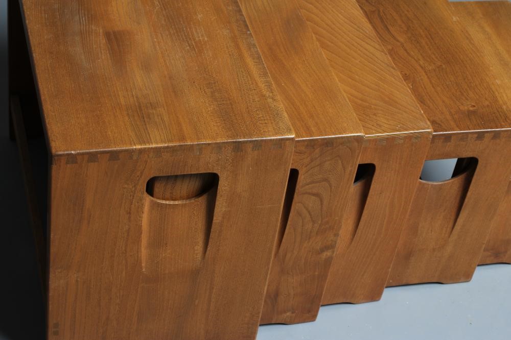 AN ERCOL LIGHT ELM NEST OF FIVE TABLES of oblong form, the solid sides pierced with inset loop Image