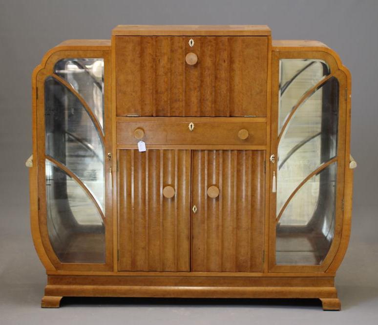 AN ART DECO BIRD'S EYE MAPLE COCKTAIL CABINET of stepped rounded oblong form Image
