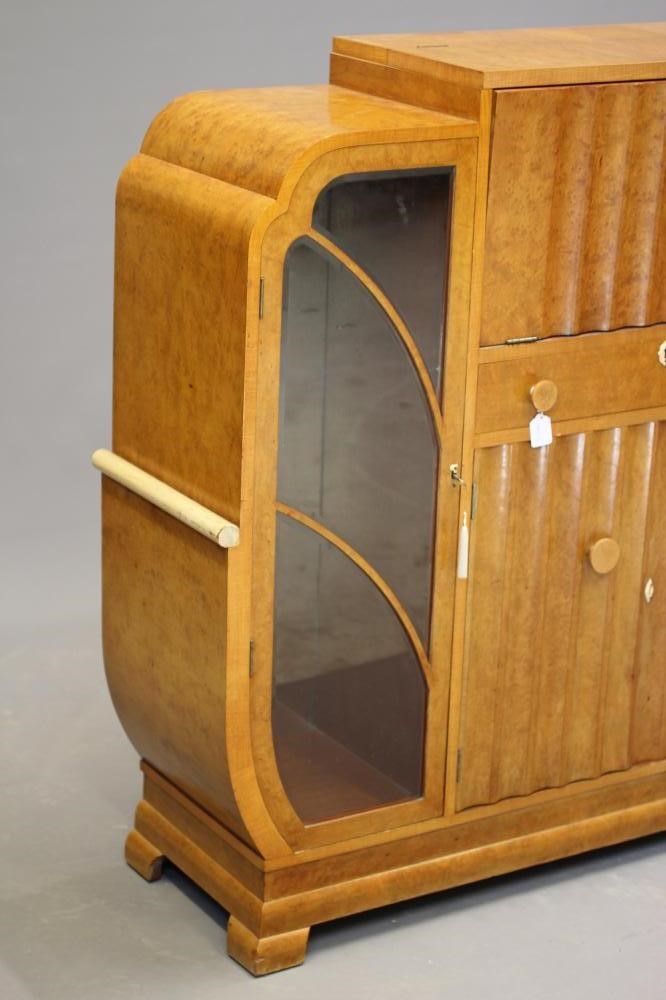 AN ART DECO BIRD'S EYE MAPLE COCKTAIL CABINET of stepped rounded oblong form Image