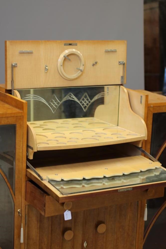 AN ART DECO BIRD'S EYE MAPLE COCKTAIL CABINET of stepped rounded oblong form Image