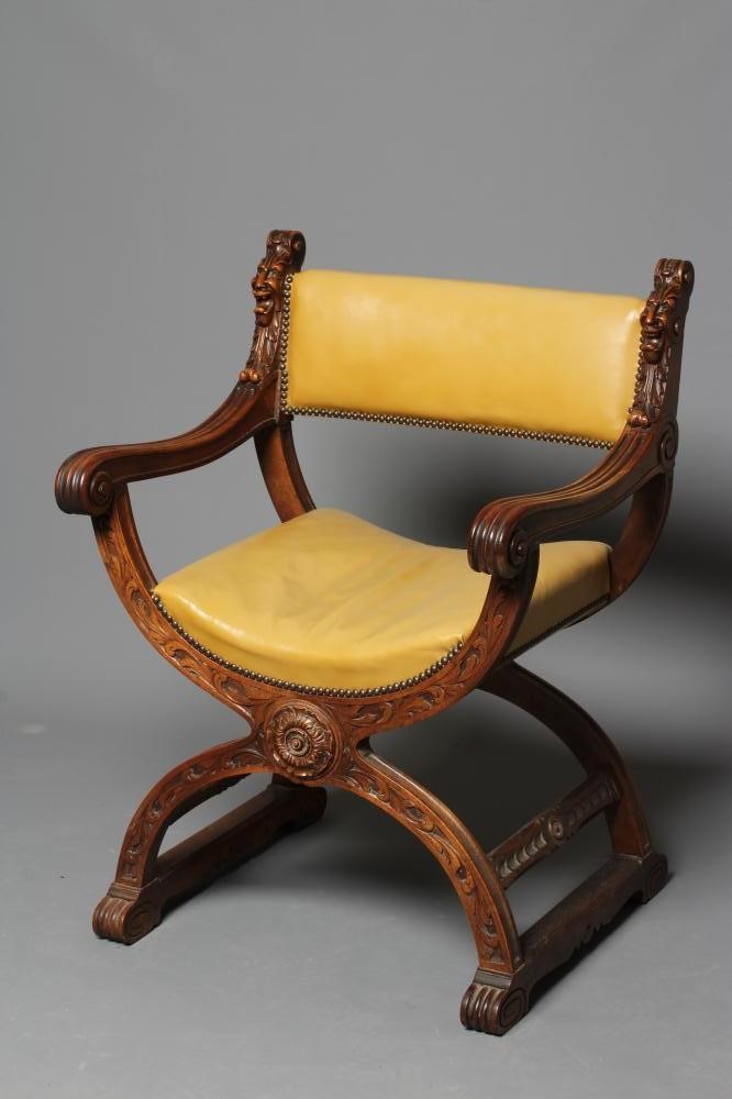 A CARVED WALNUT SAVONAROLA TYPE ARMCHAIR Image