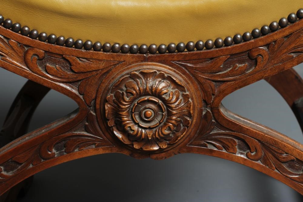 A CARVED WALNUT SAVONAROLA TYPE ARMCHAIR Image