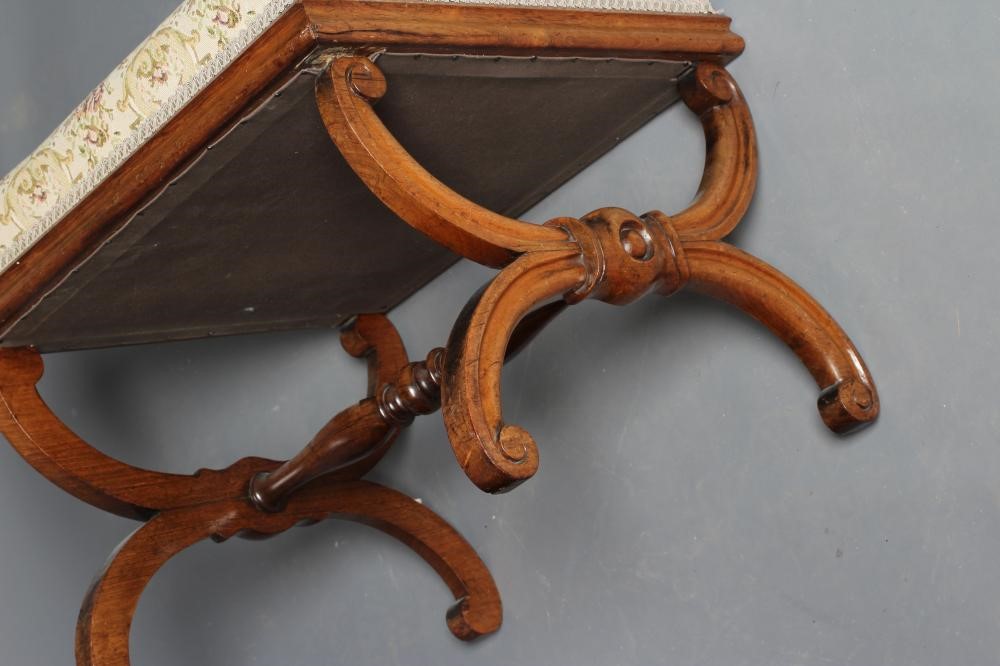 A VICTORIAN ROSEWOOD X FRAMED DRESSING STOOL of oblong form upholstered in a cream floral weave Image