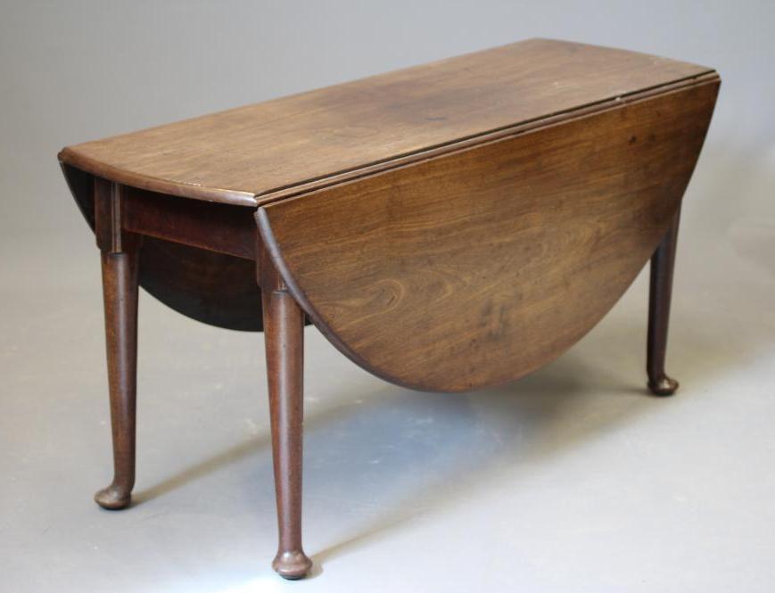 A GEORGIAN MAHOGANY DROP LEAF DINING TABLE, mid 18th century, the moulded edged oval top and plain Image