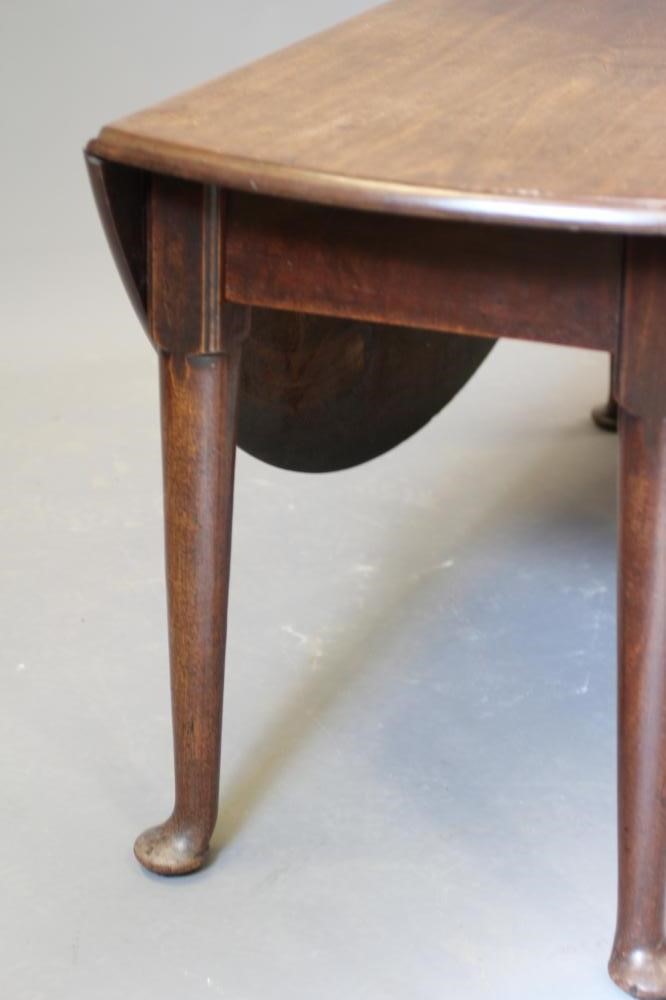 A GEORGIAN MAHOGANY DROP LEAF DINING TABLE, mid 18th century, the moulded edged oval top and plain Image
