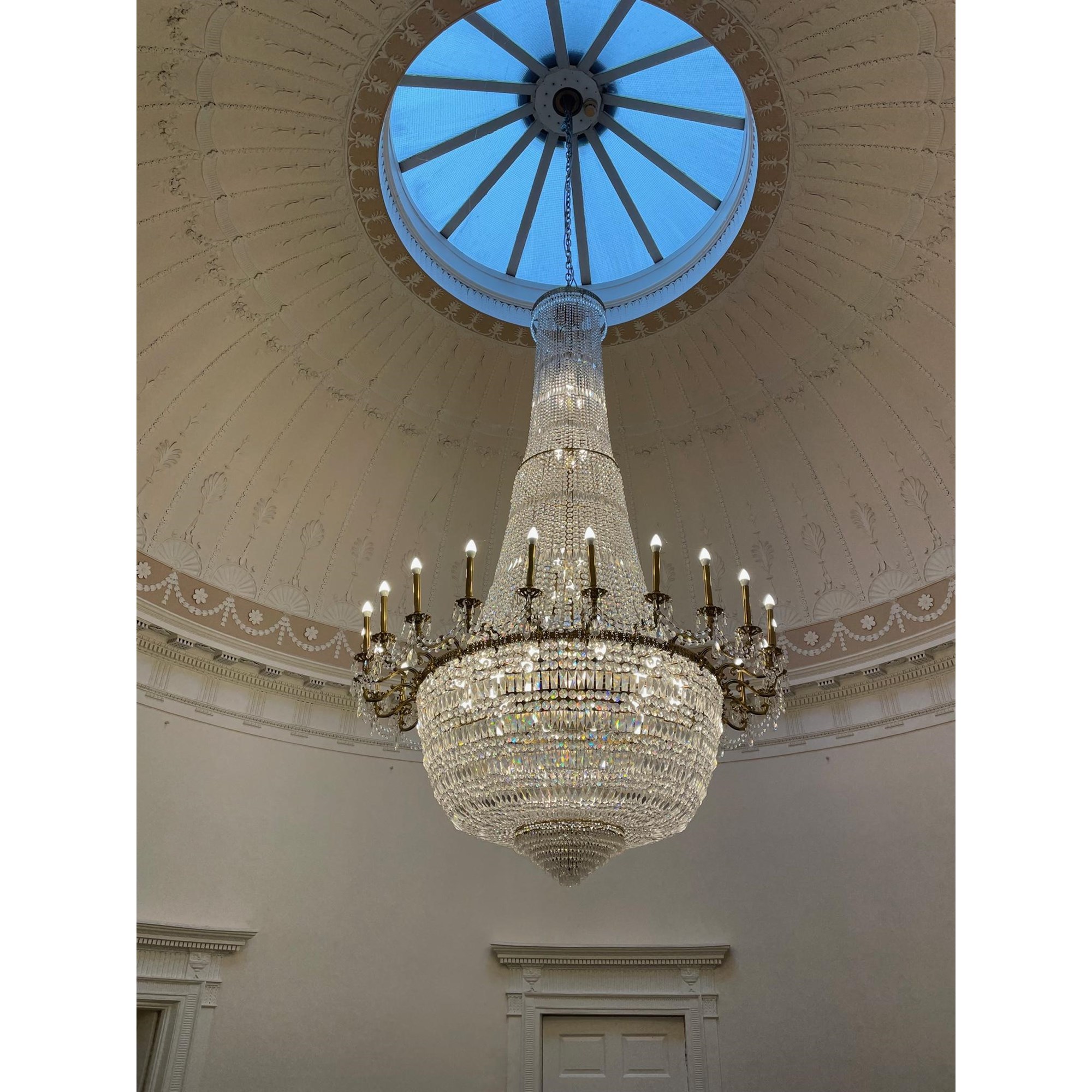 AN IMPRESSIVE GILT METAL AND CUT GLASS TWENTY-FOUR FLAME CHANDELIER Image