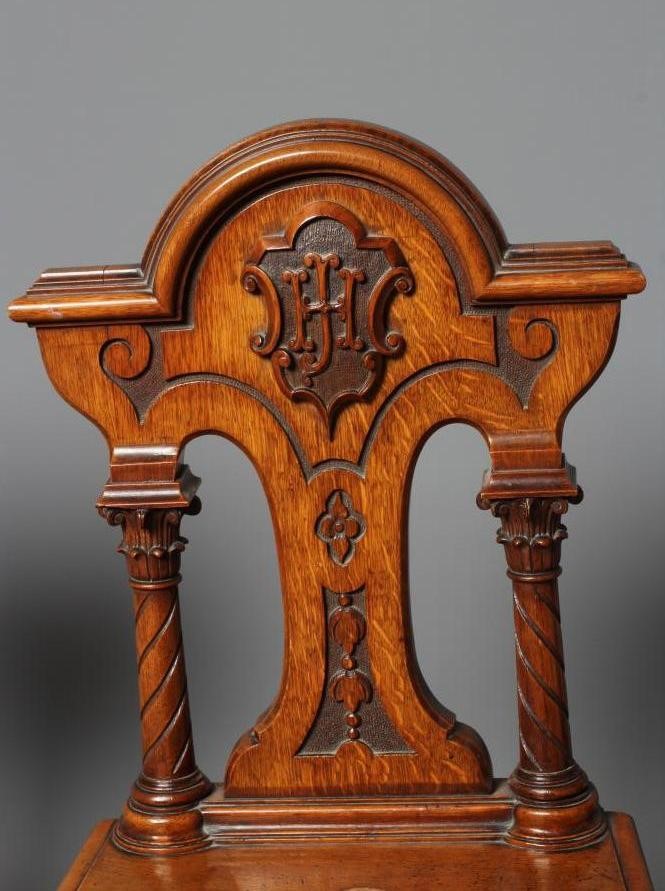 A PAIR OF VICTORIAN GOTHIC CARVED LIGHT OAK HALL CHAIRS Image