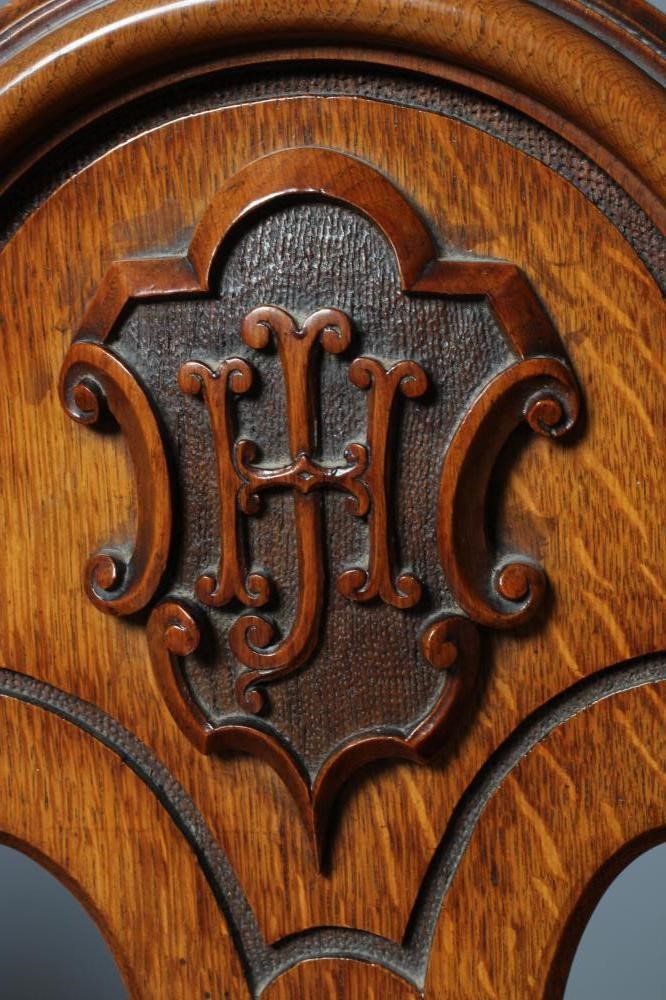 A PAIR OF VICTORIAN GOTHIC CARVED LIGHT OAK HALL CHAIRS Image