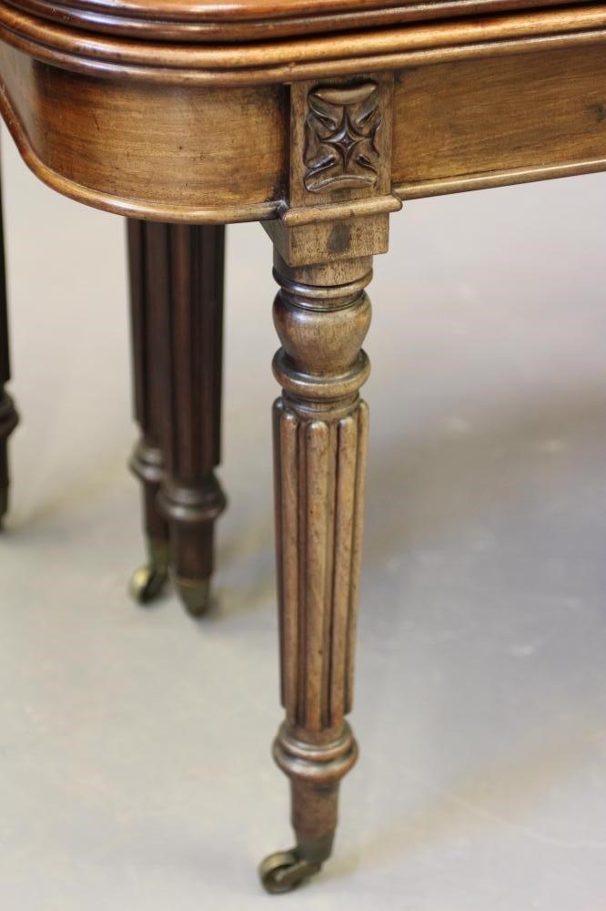 A REGENCY MAHOGANY FOLDING AND EXTENDING DINING TABLE in the manner of Gillow Image