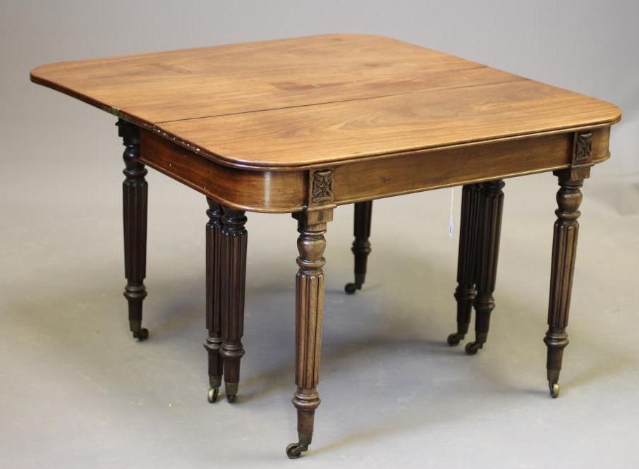 A REGENCY MAHOGANY FOLDING AND EXTENDING DINING TABLE in the manner of Gillow Image