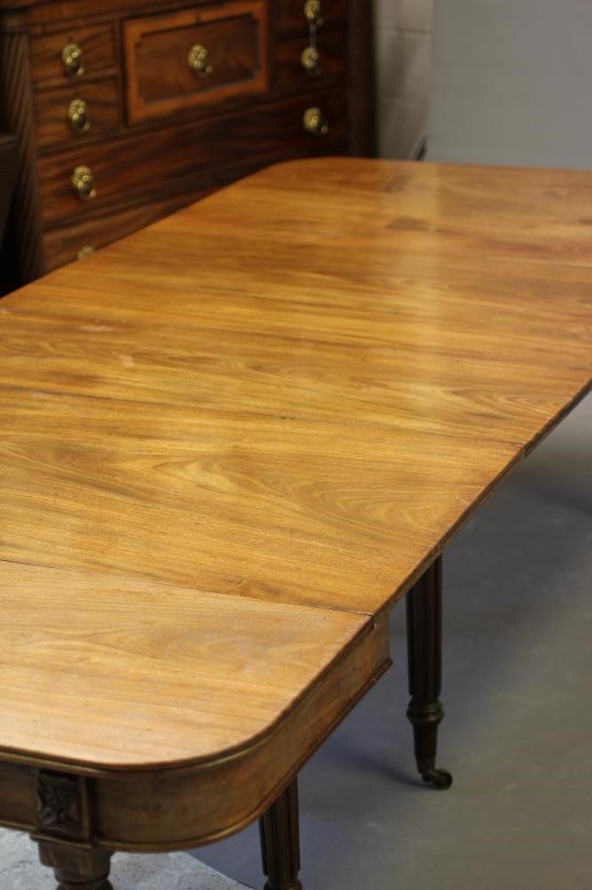 A REGENCY MAHOGANY FOLDING AND EXTENDING DINING TABLE in the manner of Gillow Image