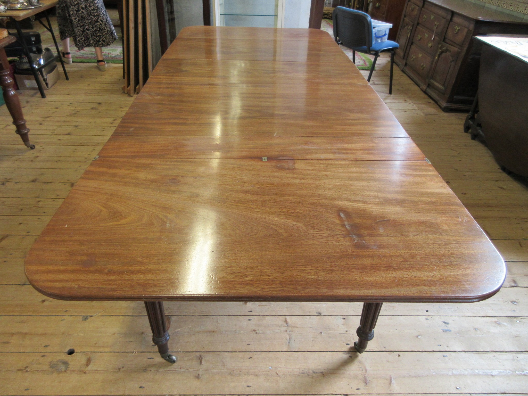 A REGENCY MAHOGANY FOLDING AND EXTENDING DINING TABLE in the manner of Gillow Image
