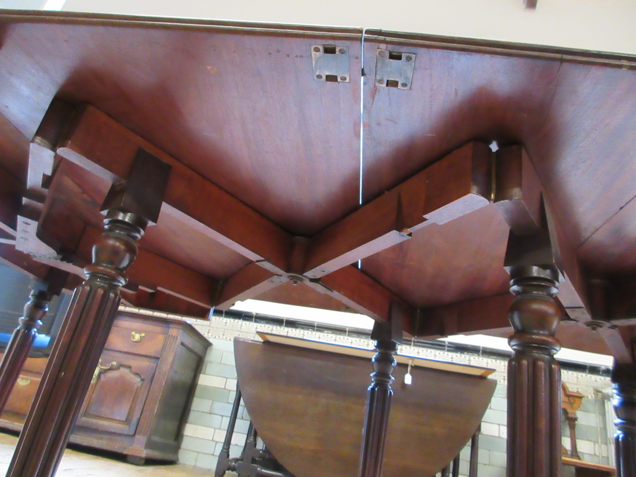 A REGENCY MAHOGANY FOLDING AND EXTENDING DINING TABLE in the manner of Gillow Image