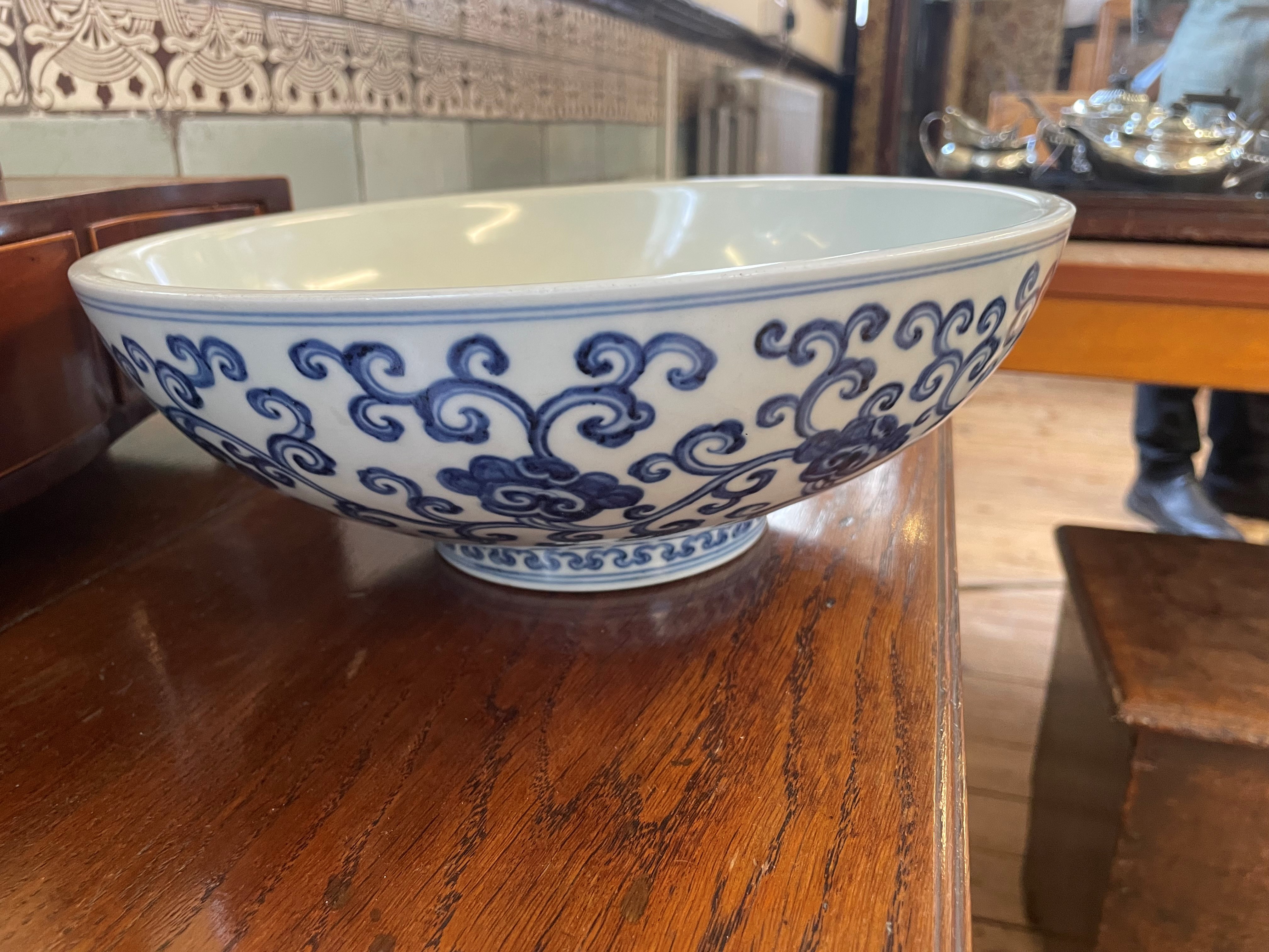 A CHINESE PORCELAIN SHALLOW BOWL of plain circular form, the exterior painted in underglaze blue Image