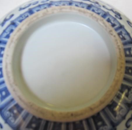 A CHINESE PORCELAIN SHALLOW BOWL of plain circular form, the exterior painted in underglaze blue Image