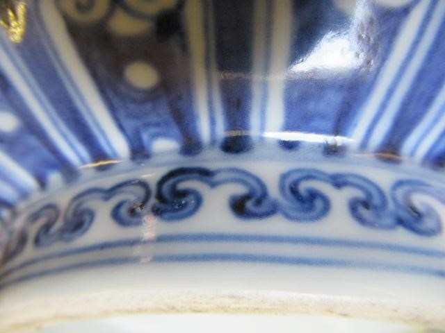 A CHINESE PORCELAIN SHALLOW BOWL of plain circular form, the exterior painted in underglaze blue Image