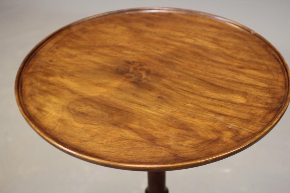 A GEORGIAN MAHOGANY TILT TOP TABLE, c.1800, the dished circular top on turned vase stem, the tripod Image