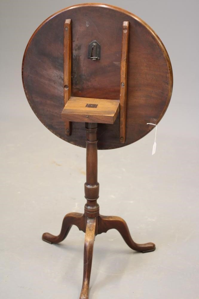 A GEORGIAN MAHOGANY TILT TOP TABLE, c.1800, the dished circular top on turned vase stem, the tripod Image