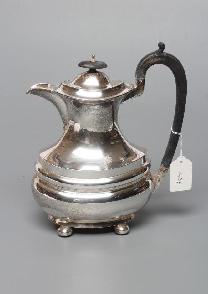A SILVER COFFEE POT Image