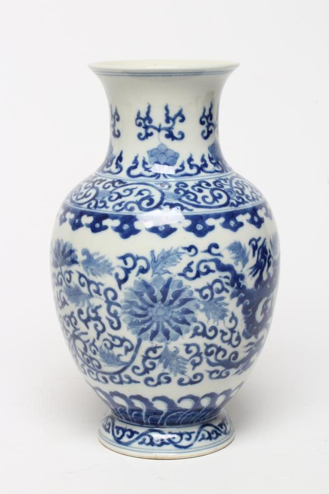 A CHINESE PORCELAIN VASE of baluster form, painted in underglaze blue with scrolling foliage within Image
