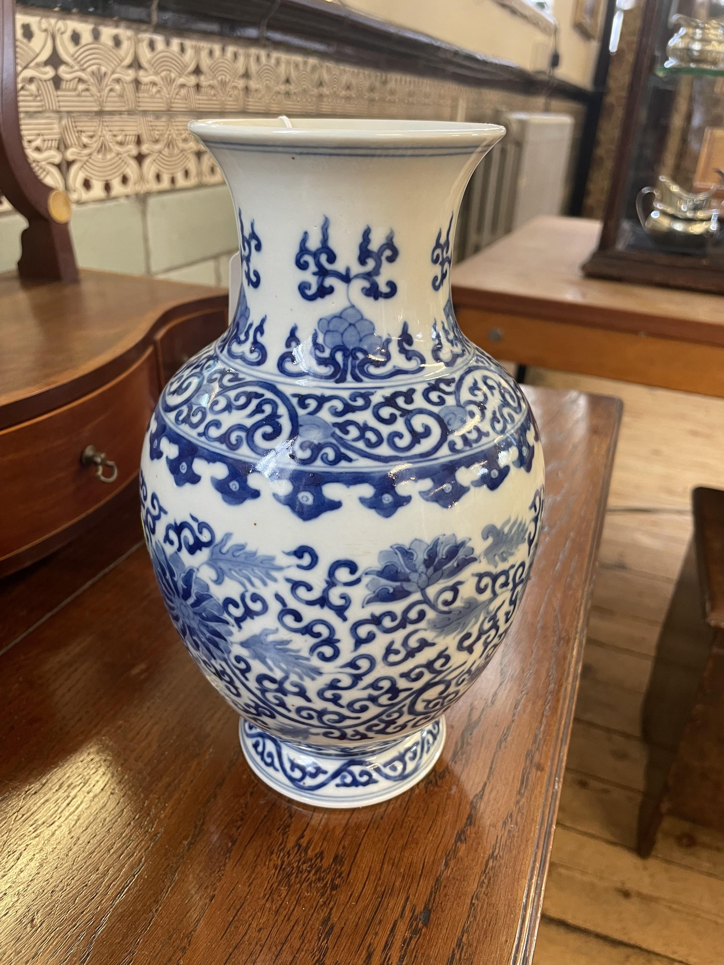 A CHINESE PORCELAIN VASE of baluster form, painted in underglaze blue with scrolling foliage within Image