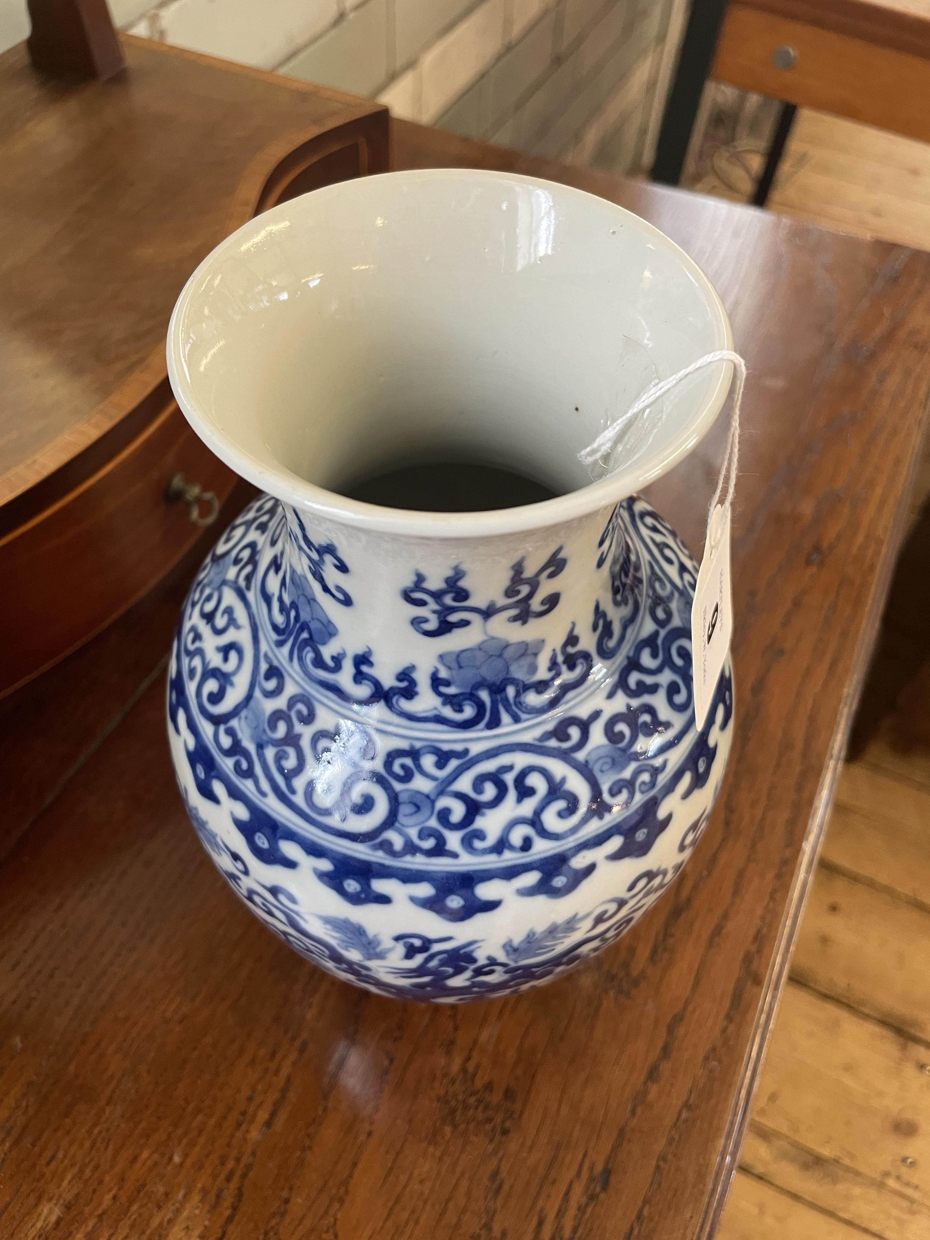 A CHINESE PORCELAIN VASE of baluster form, painted in underglaze blue with scrolling foliage within Image