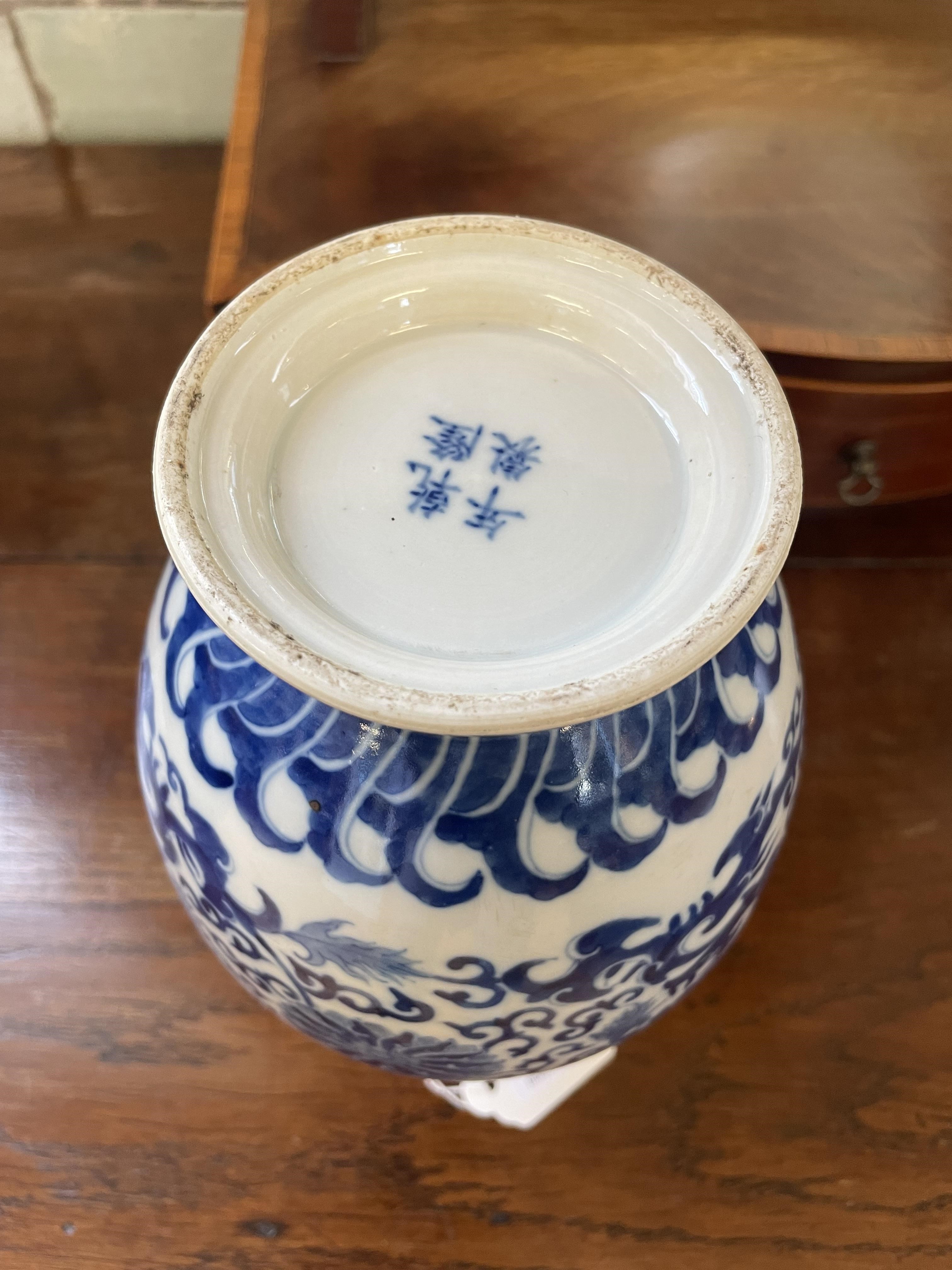 A CHINESE PORCELAIN VASE of baluster form, painted in underglaze blue with scrolling foliage within Image