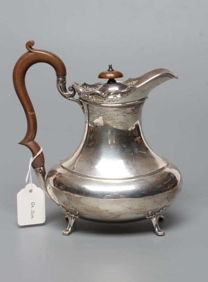A SILVER COFFEE POT Image